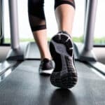 A woman goes running on a treadmill, one of the mental health strategies for teens and adults dealing with stress.